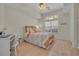 Cozy bedroom with natural light, a comfortable bed, and a ceiling fan at 139 Olde Canal Loop, Pawleys Island, SC 29585