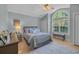 Comfortable bedroom featuring a large window, hardwood floors, and a cozy rug at 139 Olde Canal Loop, Pawleys Island, SC 29585
