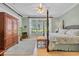Spacious bedroom featuring a four-poster bed, hardwood floors, and natural light at 139 Olde Canal Loop, Pawleys Island, SC 29585