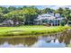 Picturesque view of the elegant clubhouse overlooking the golf course and pond, perfect for social gatherings at 139 Olde Canal Loop, Pawleys Island, SC 29585