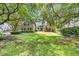 Charming brick home with lush green lawn, mature trees, and inviting front entrance at 139 Olde Canal Loop, Pawleys Island, SC 29585