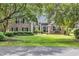 Charming brick home with lush green lawn, mature trees, and inviting front entrance at 139 Olde Canal Loop, Pawleys Island, SC 29585