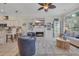 Living room with a fireplace, TV, built-in shelving, kitchen bar, and a comfortable seating area at 139 Olde Canal Loop, Pawleys Island, SC 29585