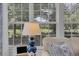 Close up of side table with lamp and couch in front of windows with golf course view at 139 Olde Canal Loop, Pawleys Island, SC 29585