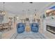 Comfortable living space with blue chairs, tile flooring, fireplace, and a breakfast nook at 139 Olde Canal Loop, Pawleys Island, SC 29585