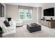 Comfortable bonus room featuring a plush sectional sofa, ottoman, and a large screen television at 1408 Whistling Straits Way, Sunset Beach, NC 28468