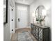 Welcoming entryway with a modern console table, decorative mirror, and stylish lighting at 1408 Whistling Straits Way, Sunset Beach, NC 28468