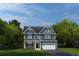 Charming two-story home with a two-car garage, a well-maintained lawn and beautiful landscaping at 1408 Whistling Straits Way, Sunset Beach, NC 28468