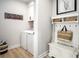 Efficient laundry room and drop zone with shelving and hanging storage at 1408 Whistling Straits Way, Sunset Beach, NC 28468