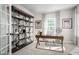 Stylish home office featuring built-in shelving, a modern desk, and plenty of natural light at 1408 Whistling Straits Way, Sunset Beach, NC 28468