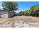 View of the backyard, surrounded by mature trees, with a storage shed at 1416 Edge Dr., North Myrtle Beach, SC 29582