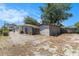 View of the backyard, surrounded by mature trees, with a storage shed at 1416 Edge Dr., North Myrtle Beach, SC 29582