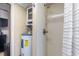Functional bathroom with shower, shelving unit, and exposed water heater at 1416 Edge Dr., North Myrtle Beach, SC 29582
