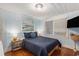Inviting bedroom featuring hardwood floors, stylish lamps, a comfortable bed, and natural light at 1416 Edge Dr., North Myrtle Beach, SC 29582