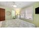 Bright bedroom with a queen bed, flat screen tv, dresser and serene green walls at 1416 Edge Dr., North Myrtle Beach, SC 29582