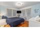 Charming bedroom with hardwood floors, nautical decor, a comfortable bed, and natural light from the windows at 1416 Edge Dr., North Myrtle Beach, SC 29582