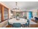 Open-concept dining area with a modern chandelier, wood floors, and stylish decor with lots of natural light at 1416 Edge Dr., North Myrtle Beach, SC 29582