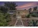 Charming home featuring a landscaped front yard with a tiled pathway leading to a screened-in porch at 1416 Edge Dr., North Myrtle Beach, SC 29582