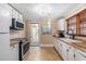 Bright and airy kitchen featuring white cabinets, an open doorway, and modern appliances at 1416 Edge Dr., North Myrtle Beach, SC 29582