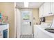 Laundry area and exterior door with white washer and dryer at 1416 Edge Dr., North Myrtle Beach, SC 29582