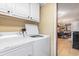 Laundry area with white washer and dryer adjacent to kitchen at 1416 Edge Dr., North Myrtle Beach, SC 29582