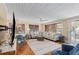 Open-concept living room with hardwood floors, a neutral area rug, and a large sectional couch at 1416 Edge Dr., North Myrtle Beach, SC 29582