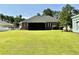 An expansive, well-maintained backyard featuring green grass and a screened-in porch at 1421 Shoreline Dr., Myrtle Beach, SC 29577