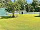 A beautiful, spacious backyard featuring lush green grass, a shed, and a white privacy fence at 1421 Shoreline Dr., Myrtle Beach, SC 29577