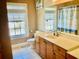 Bathroom features a wood vanity, large mirror, and a window with natural light at 1421 Shoreline Dr., Myrtle Beach, SC 29577