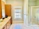 Bright bathroom features double vanity, tile floor, and walk-in shower with glass door at 1421 Shoreline Dr., Myrtle Beach, SC 29577