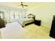 Traditional bedroom with a ceiling fan, matching dark wood furniture, and lots of natural light from the windows at 1421 Shoreline Dr., Myrtle Beach, SC 29577