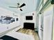Charming bedroom featuring a ceiling fan, tv, modern fixtures, and light wood laminate flooring at 1421 Shoreline Dr., Myrtle Beach, SC 29577