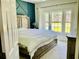 Cozy bedroom featuring a king-sized bed, accent wall, and large windows with natural light at 1421 Shoreline Dr., Myrtle Beach, SC 29577