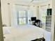Bright bedroom with a large window, white curtains, and a workspace with desk at 1421 Shoreline Dr., Myrtle Beach, SC 29577