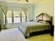Primary bedroom with a large bed, multiple windows for natural light and light teal walls at 1421 Shoreline Dr., Myrtle Beach, SC 29577