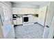 Bright laundry room features white cabinets, sink, modern washer and dryer, and tiled flooring at 1421 Shoreline Dr., Myrtle Beach, SC 29577