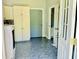 Spacious laundry room with blue tiled floors, storage cabinets, and access to a bathroom at 1421 Shoreline Dr., Myrtle Beach, SC 29577