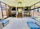 An airy screened porch featuring comfortable seating, ceiling fans, and scenic backyard views at 1421 Shoreline Dr., Myrtle Beach, SC 29577