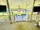 A spacious screened porch with brick steps, a ceiling fan, and an outdoor seating area at 1421 Shoreline Dr., Myrtle Beach, SC 29577