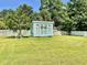 Charming backyard shed with double doors and large windows surrounded by well-kept lawn at 1421 Shoreline Dr., Myrtle Beach, SC 29577