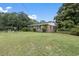A view of the home's brick exterior, set among green lawns and some trees at 169 Ole Maple St., Loris, SC 29569