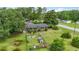 Brick home featuring fenced yard with playset and mature shade trees at 169 Ole Maple St., Loris, SC 29569