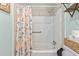Bathroom with a shower featuring a floral shower curtain, towel bar, and fresh paint at 169 Ole Maple St., Loris, SC 29569