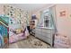 Charming bedroom with floral wallpaper, a cozy bed, and ample storage space at 169 Ole Maple St., Loris, SC 29569
