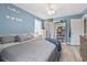Comfortable bedroom featuring blue walls, fan, and a cozy bed, offering a peaceful retreat at 169 Ole Maple St., Loris, SC 29569