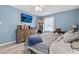 Cozy bedroom with blue walls, dresser with TV, and ample natural light at 169 Ole Maple St., Loris, SC 29569