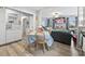 Open dining area adjacent to living room featuring wood laminate floors and view into the living room at 169 Ole Maple St., Loris, SC 29569