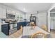 A well-lit kitchen with open dining space features white and navy blue cabinetry and updated appliances at 169 Ole Maple St., Loris, SC 29569