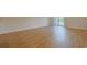 Spacious bedroom with wood-look flooring, base trim, and sliding glass door to the outside at 184 Sea Shell Dr. # 12, Murrells Inlet, SC 29576