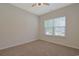An empty bedroom with neutral walls and carpet and a window at 184 Sea Shell Dr. # 12, Murrells Inlet, SC 29576